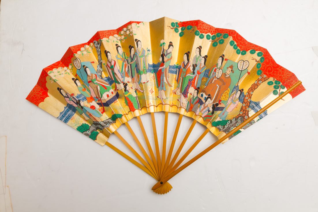 An ornate golden Noh fan painted with classical figures
