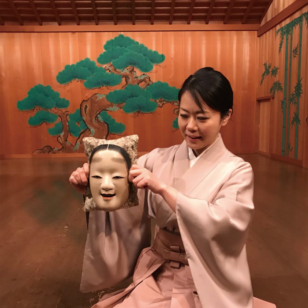 The performer presenting an authentic Noh mask